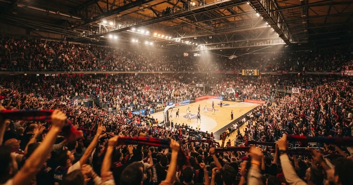 A packed sports hall under floodlights photographed from a long way off