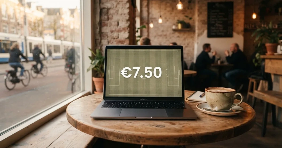 A laptop on a café table by a window onto the street